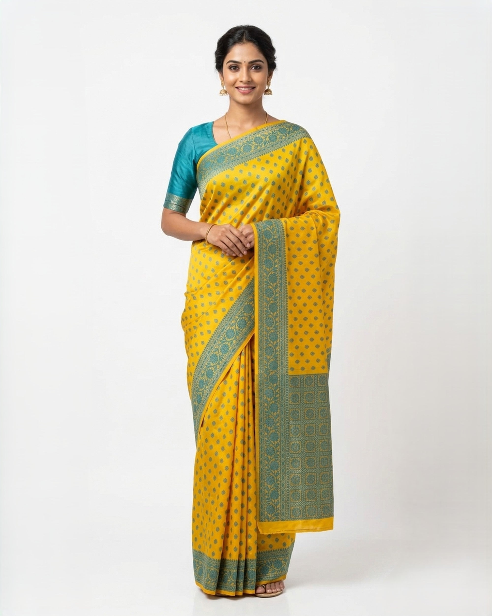 A woman elegantly modelling a mustard yellow & emerald green Banarasi silk blend saree from The Weaver's Shop, featuring all-over ethnic Zari motifs, a wide green border with a golden weave, and a matching green blouse against a white