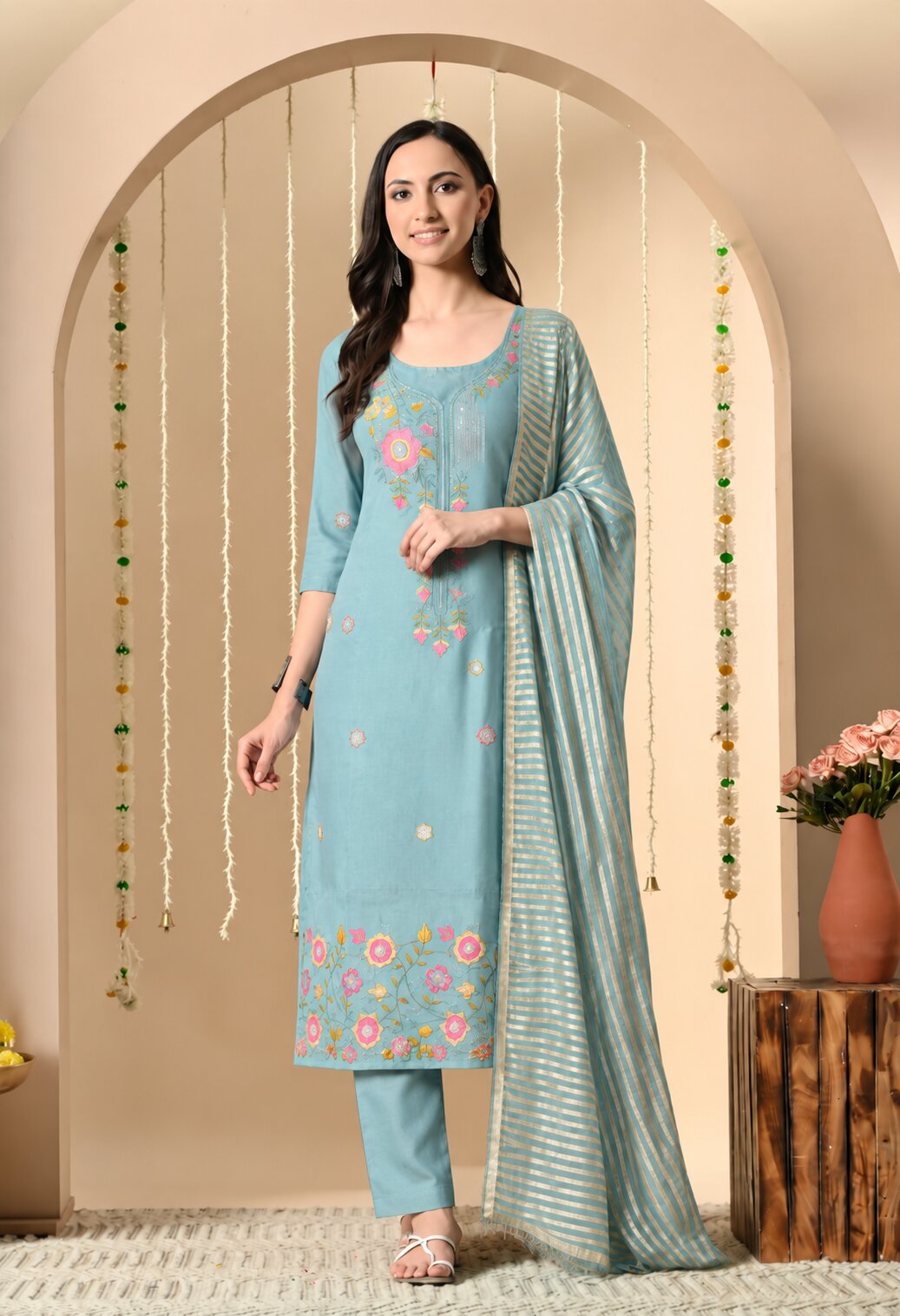 Sky blue embroidered women’s ethnic suit set featuring a floral embroidered straight kurta, matching trousers, and a striped dupatta with an elegant traditional design.