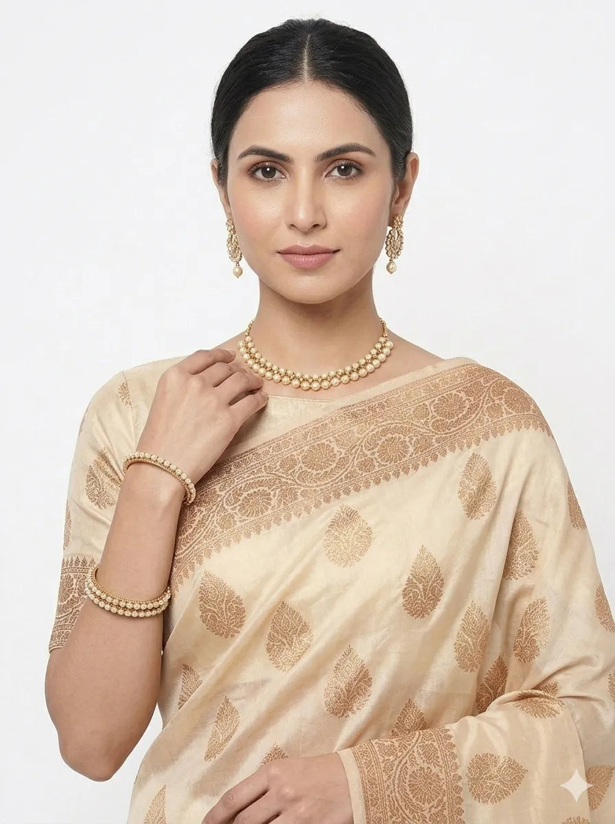 A close-up portrait of a woman wearing the Off-White & Gold-Toned Woven Banarasi Silk Saree, showcasing the exquisite golden floral Zari motifs, the rich silk-finish texture, and elegant jewellery for a sophisticated wedding look.