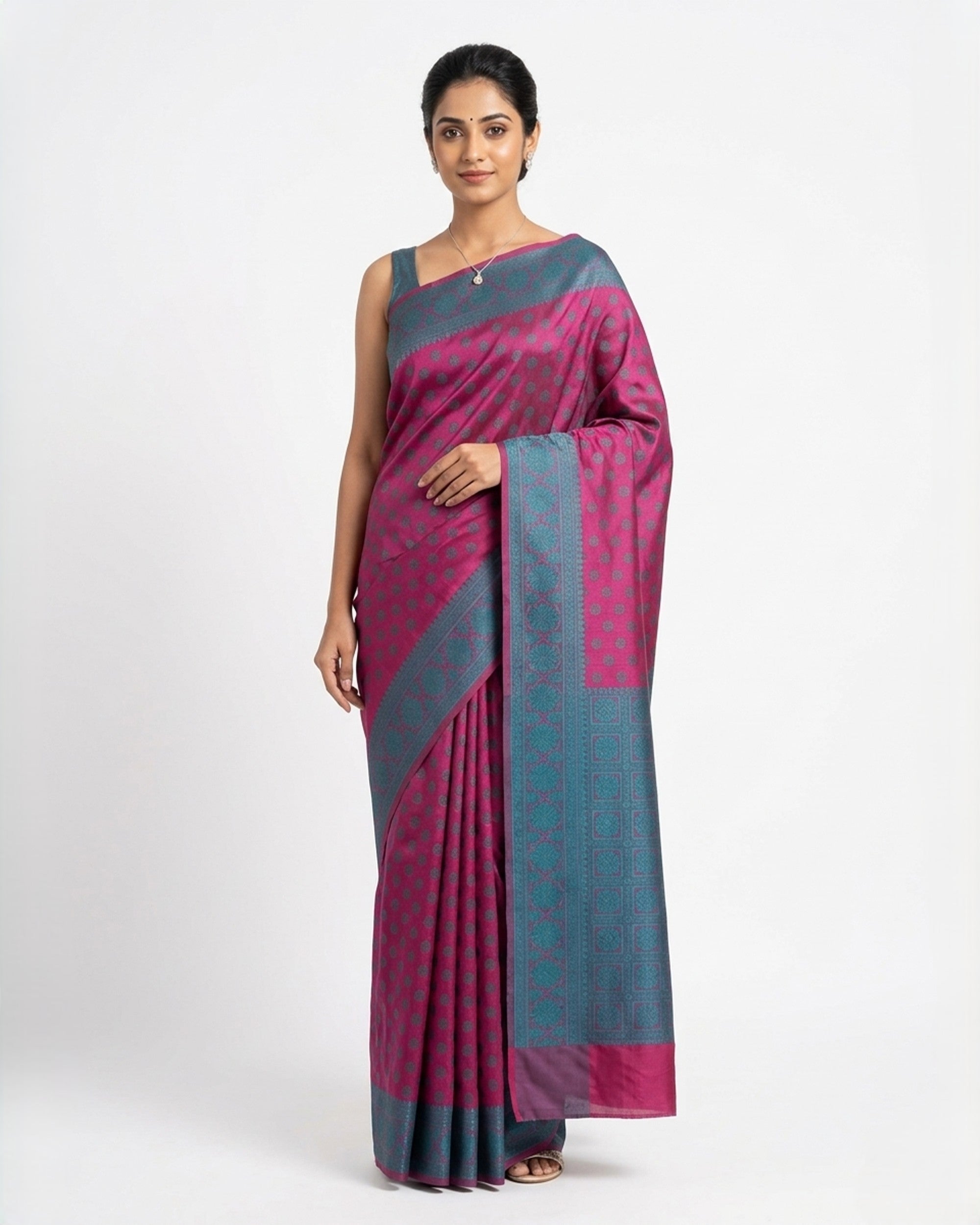 A woman elegantly modelling a magenta & charcoal grey woven Banarasi silk blend saree from The Weaver's Shop, featuring all-over Zari motifs, a wide grey border with traditional weaving, and a matching sleeveless blouse against a white background.