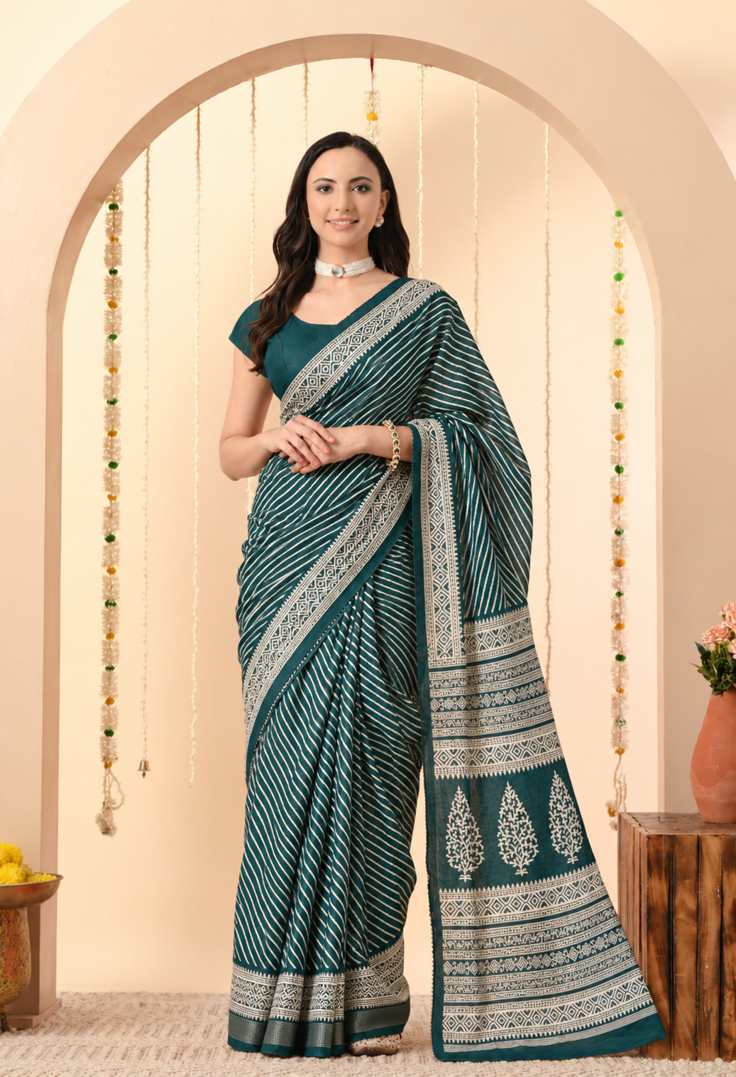 Pair it with an ivory or matching teal blouse, traditional earrings and bangles for a refined festive look.