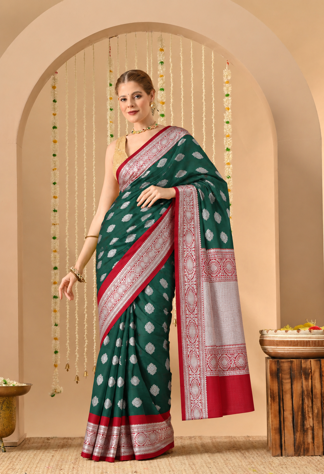 Woman wearing a bottle green Banarasi silk saree with silver zari work and maroon border.
