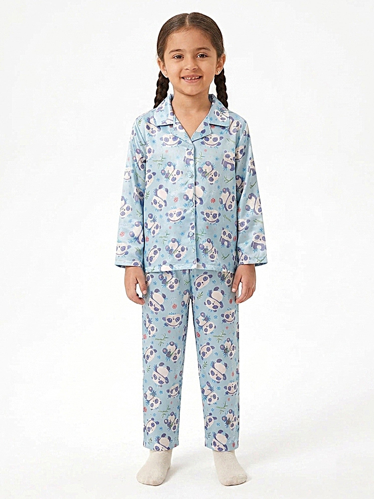 A young girl wearing a light blue and lavender panda-printed satin button-down nightsuit set.