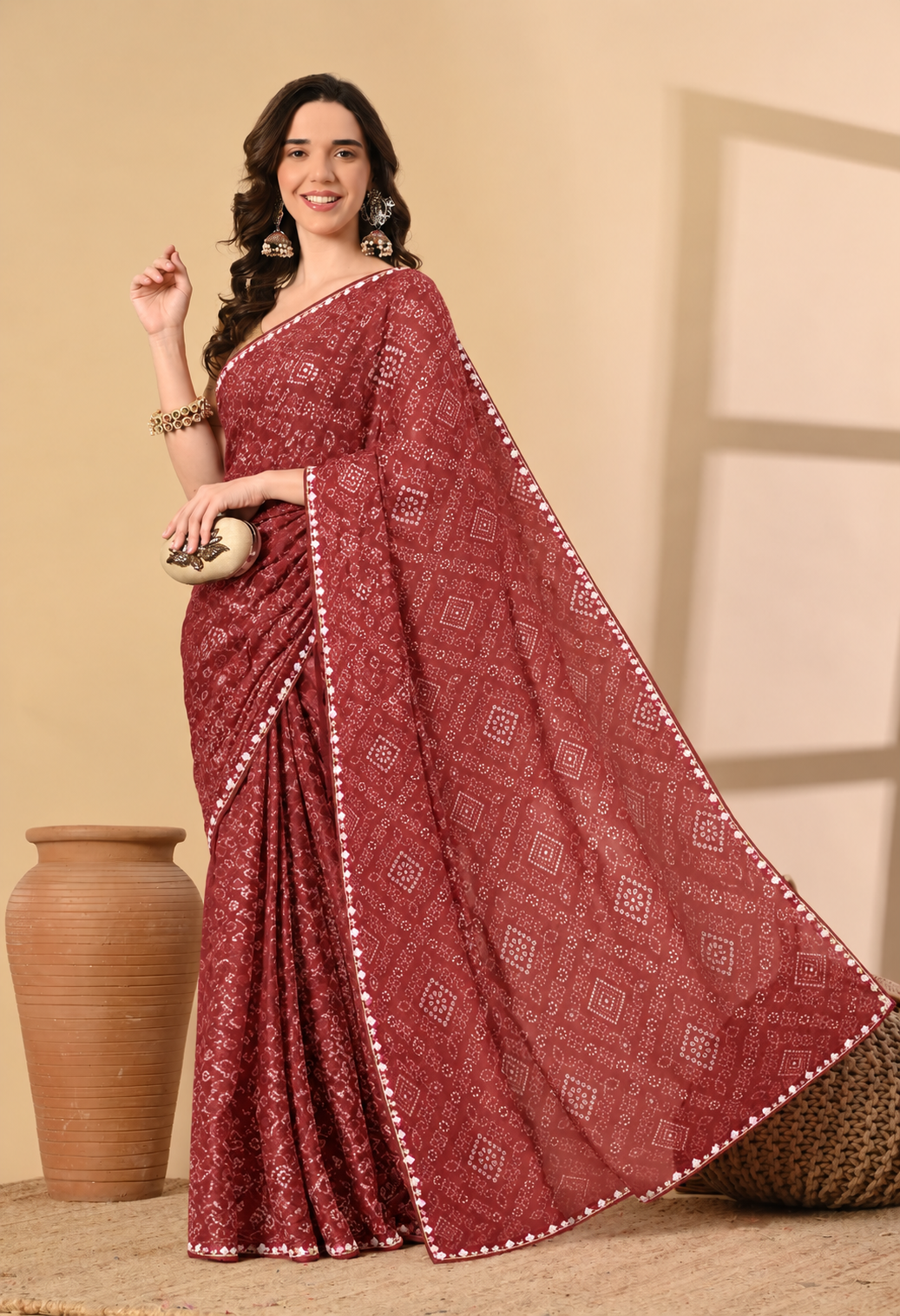 Maroon georgette saree with traditional geometric printed motifs and decorative border.
