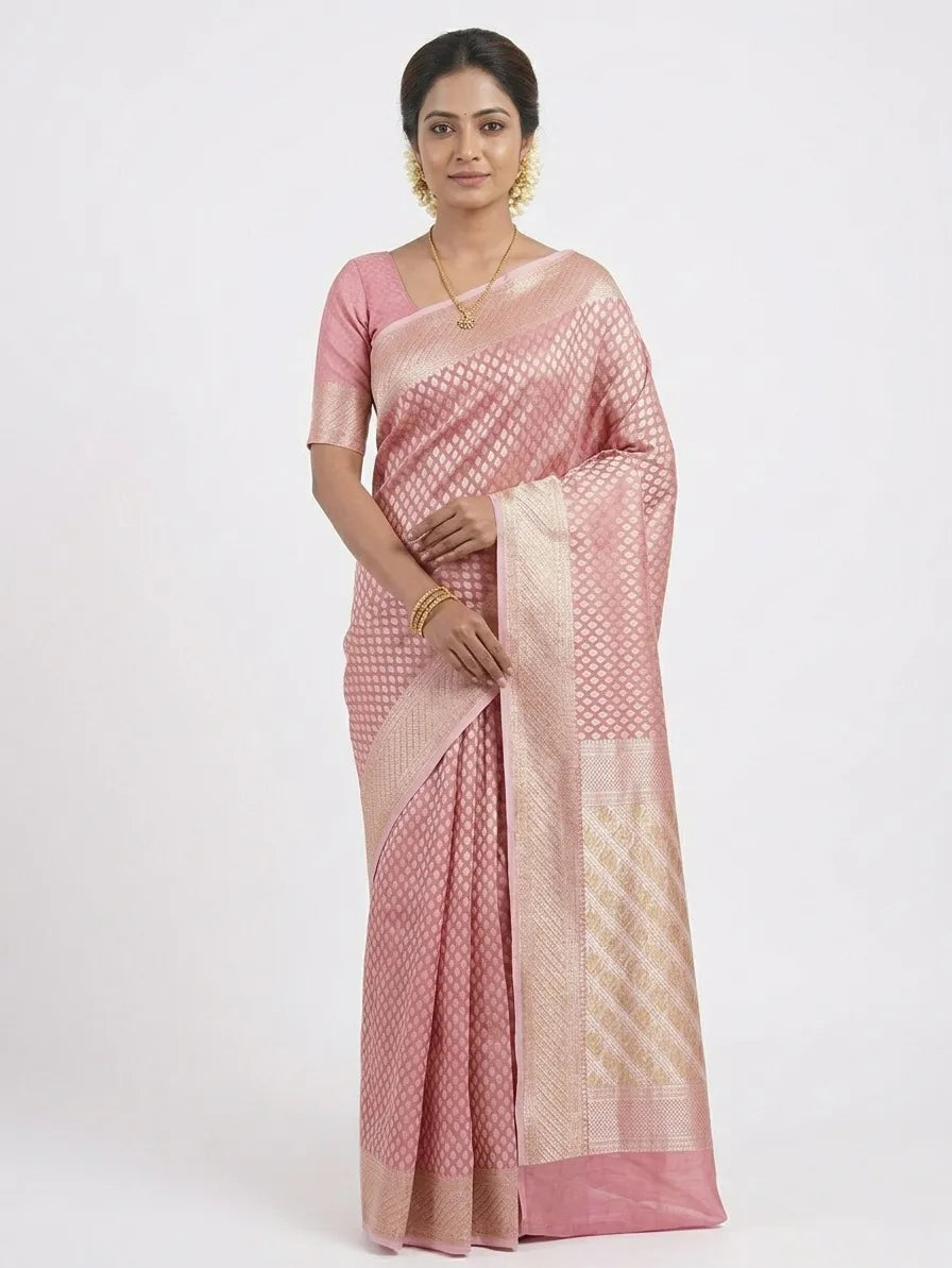 Model in a candy pink Banarasi silk blend saree featuring an intricate gold-toned woven jaal pattern, broad ornate borders, and a geometric pallu.