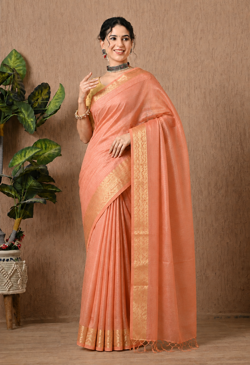 Peach cotton saree with golden woven geometric border and tassel detailing