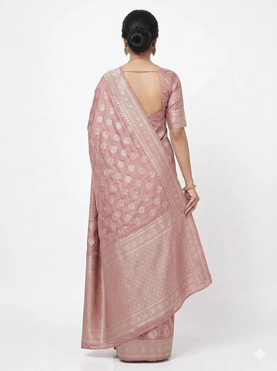 Back view of a woman wearing a Dusty Rose & Silver Woven Banarasi Silk Blend Saree, showcasing the dense silver Zari pallu and a matching blouse with a traditional deep-back design.