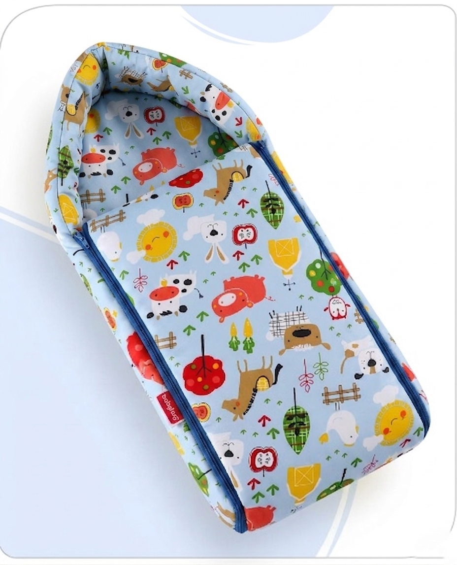 Light blue baby sleeping bag with colorful farm animal illustrations and blue side zippers.
