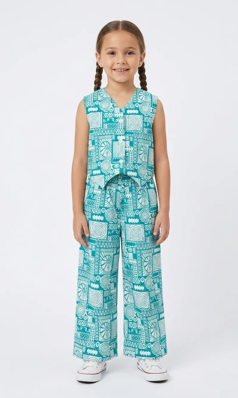 Young girl in a teal and white geometric printed cotton co-ord set featuring a waistcoat top and wide-leg pants.
