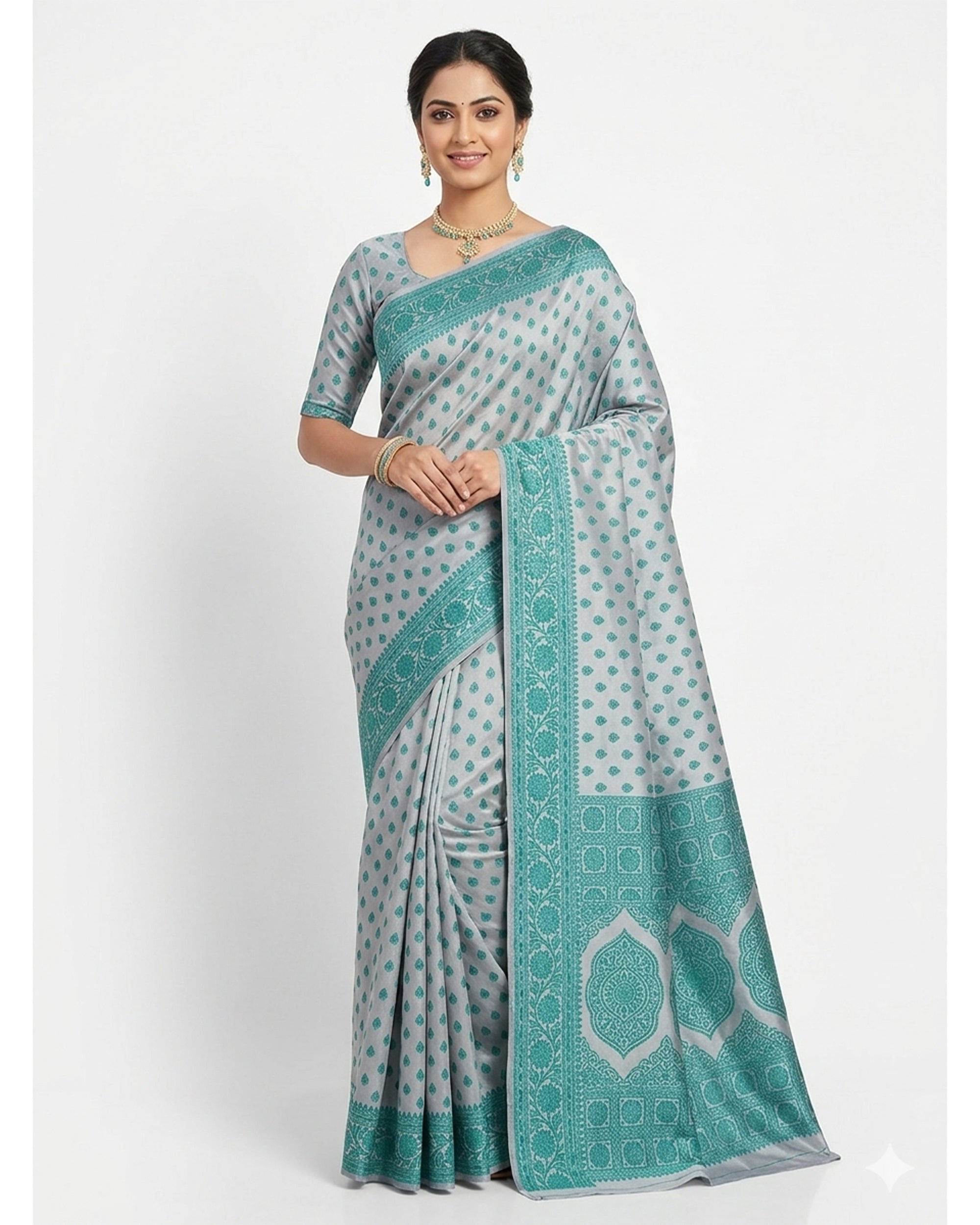 Woman wearing a grey and teal Chanderi silk blend saree with an all-over ethnic motif pattern and ornate border.