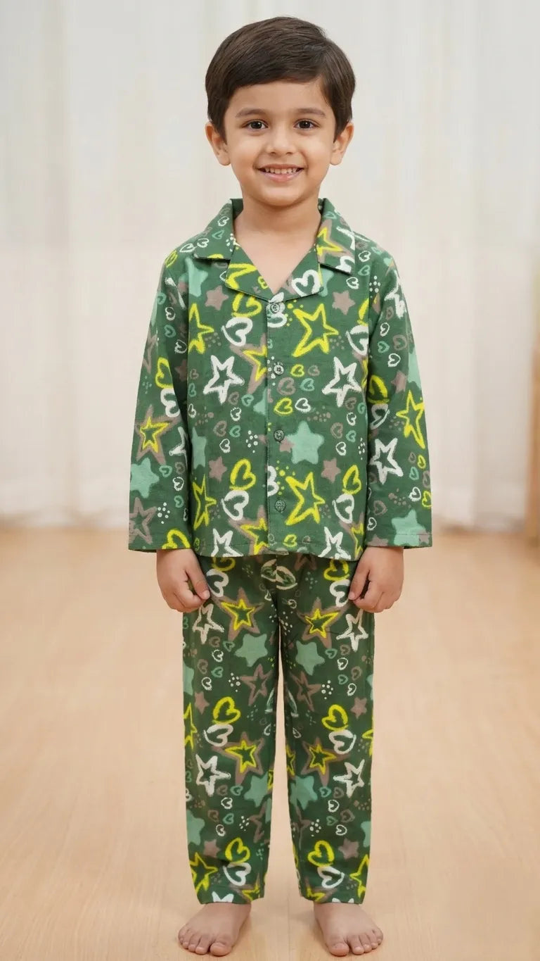 Young boy in a dark green cotton night suit with yellow and white star prints, featuring a button-up notched collar shirt and matching pyjamas.
