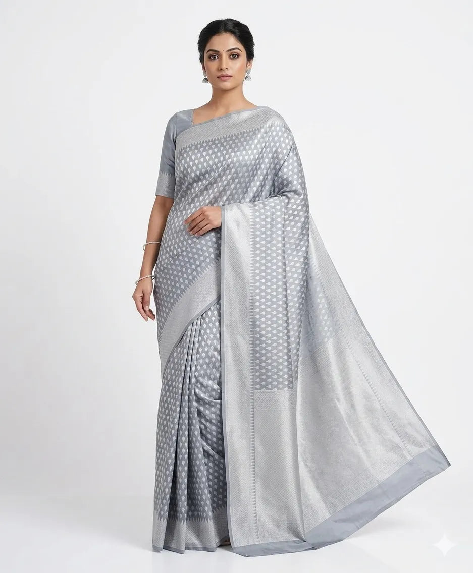 Woman in a silver Banarasi art silk saree with woven Zari details, posing against a white background.