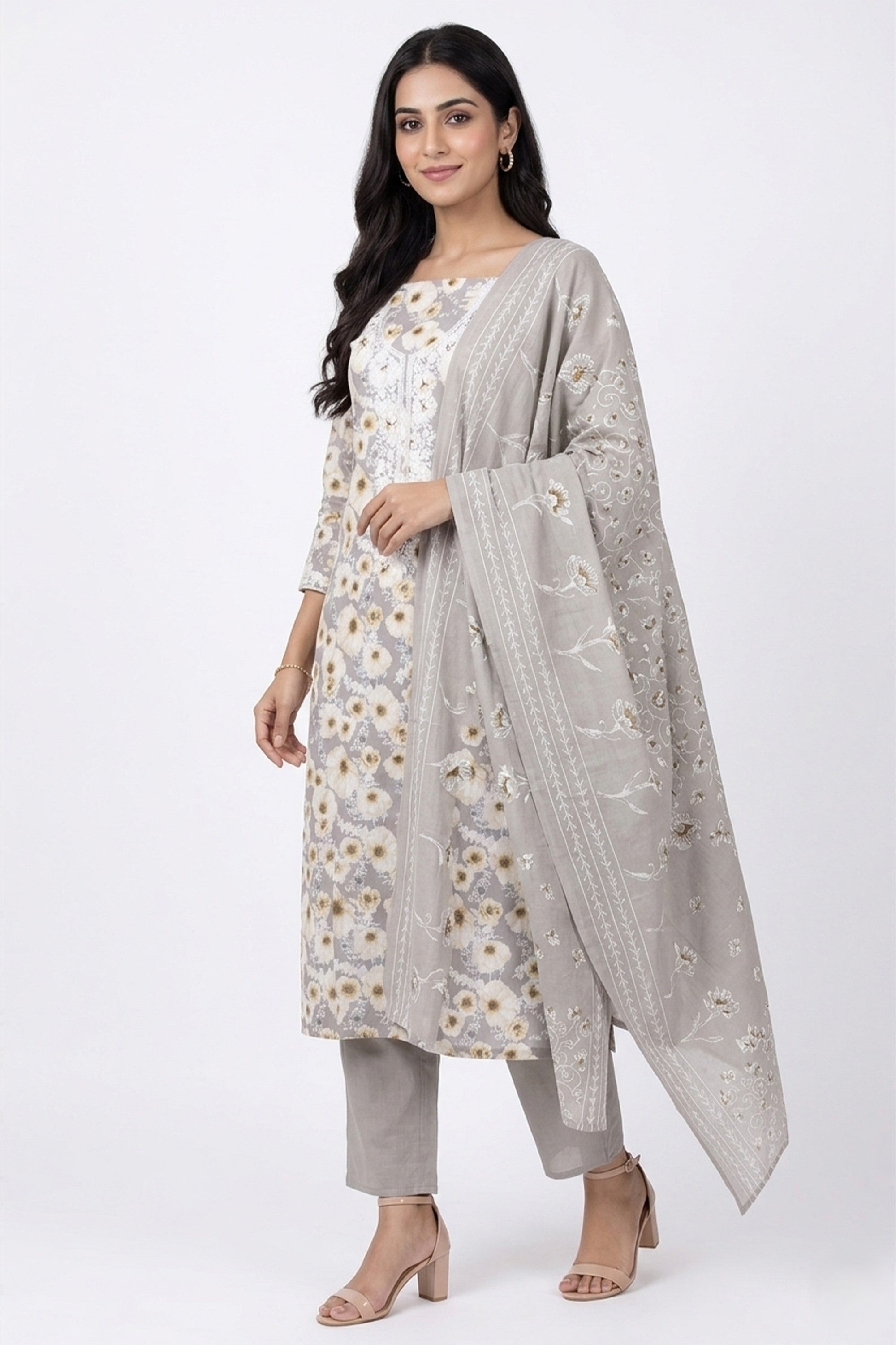 A dove grey cotton unstitched suit featuring a dense white floral print and a white embroidered neckline, paired with a matching printed dupatta.
