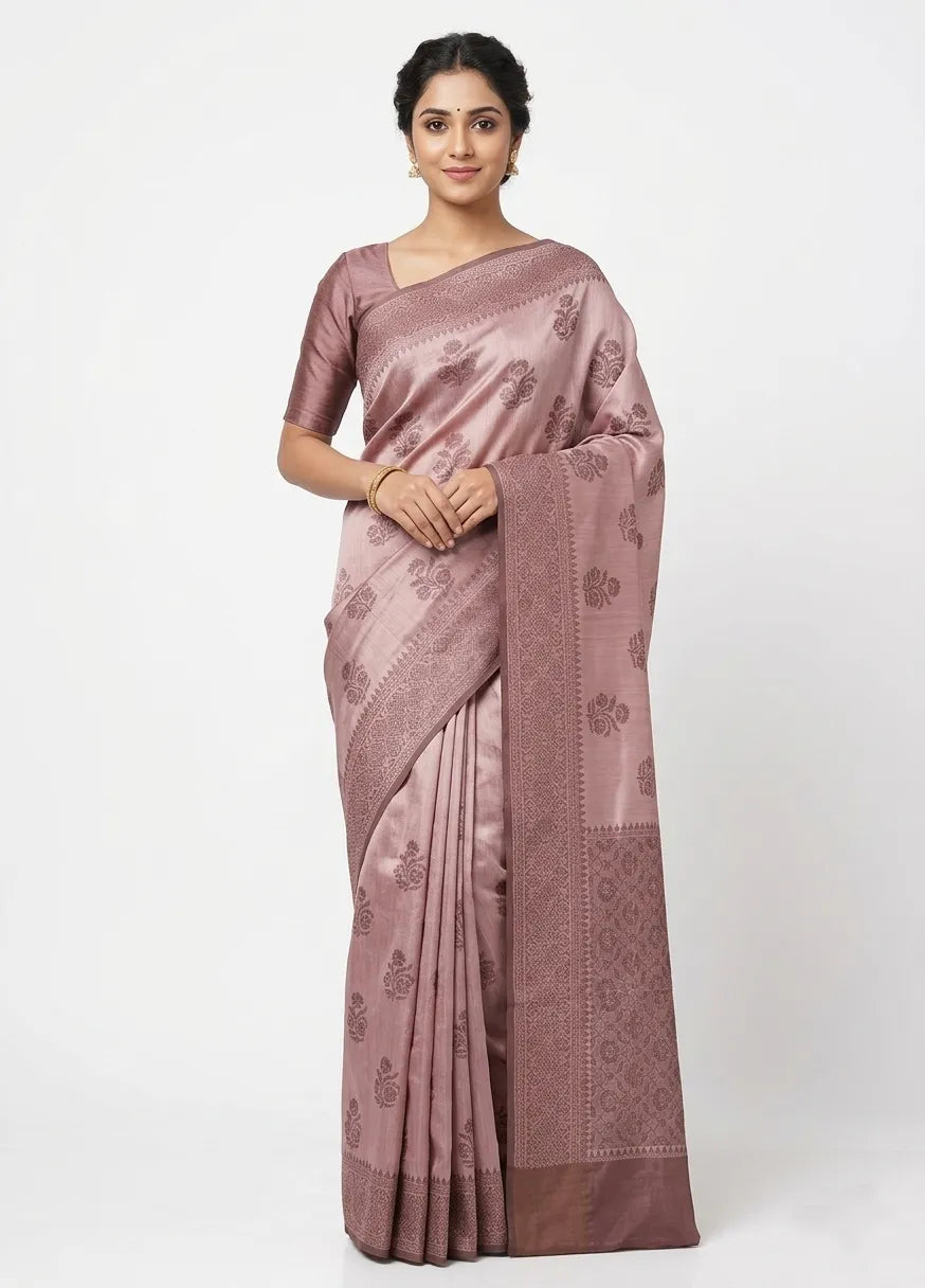 Woman in a mauve Banarasi silk blend saree featuring a woven Zari border and floral motifs, posing against a white background.