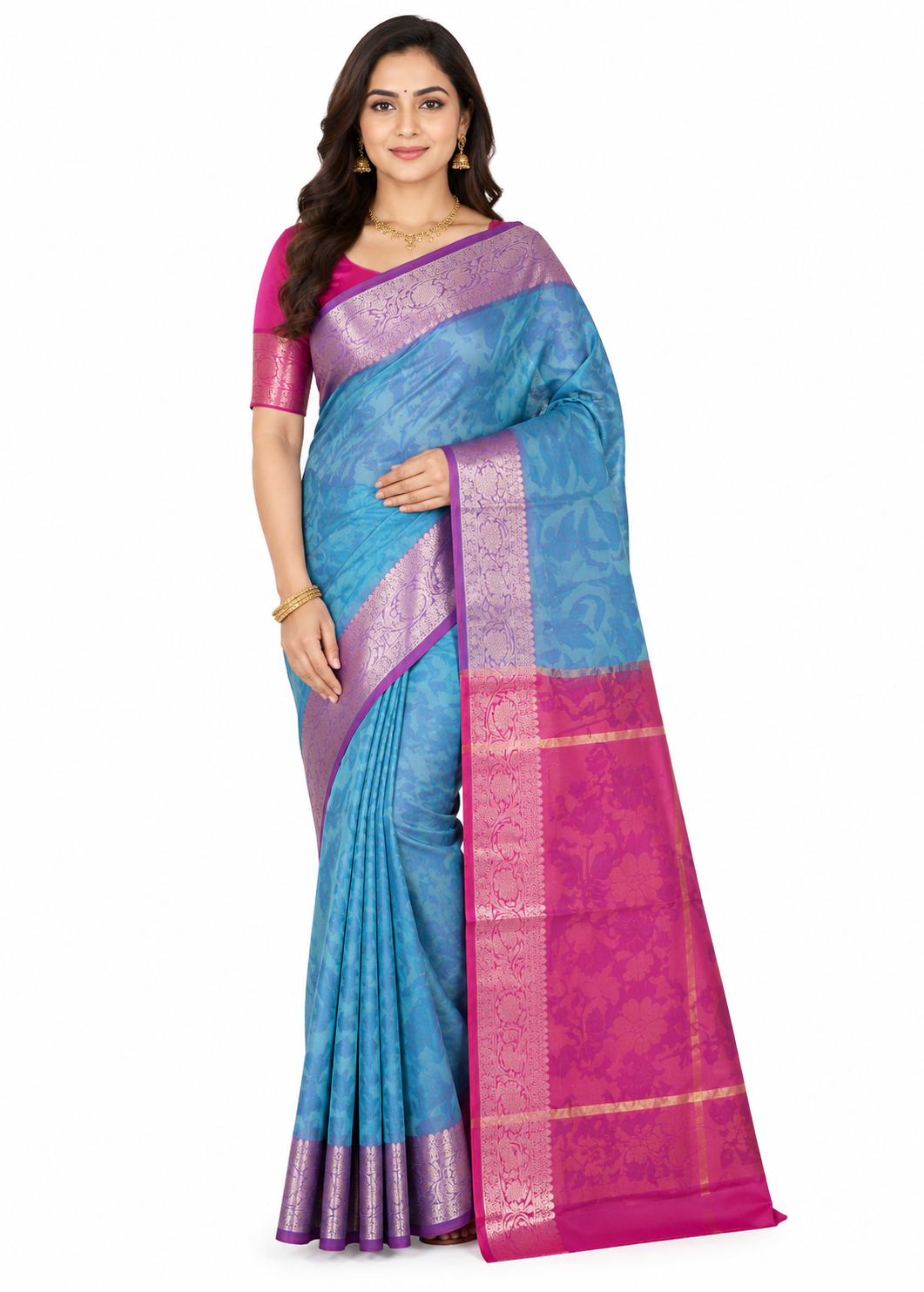 A woman posing in a blue-grey Banarasi silk saree with intricate silver woven motifs and a contrasting pink and gold-toned zari border.