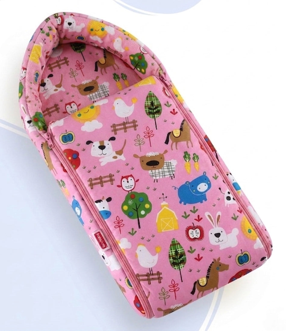 Pink baby sleeping bag with detailed farm animal illustrations.
