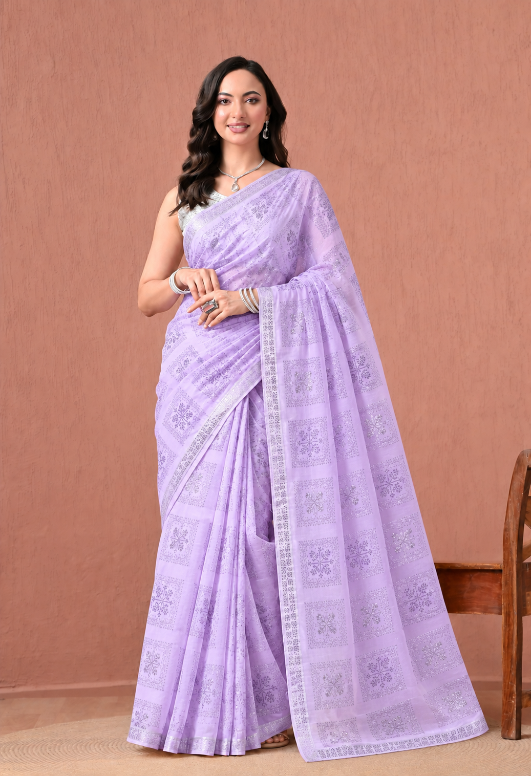 Women’s lavender purple printed chiffon saree featuring intricate traditional patterns and a matching decorative border, styled elegantly for festive and ethnic occasions.