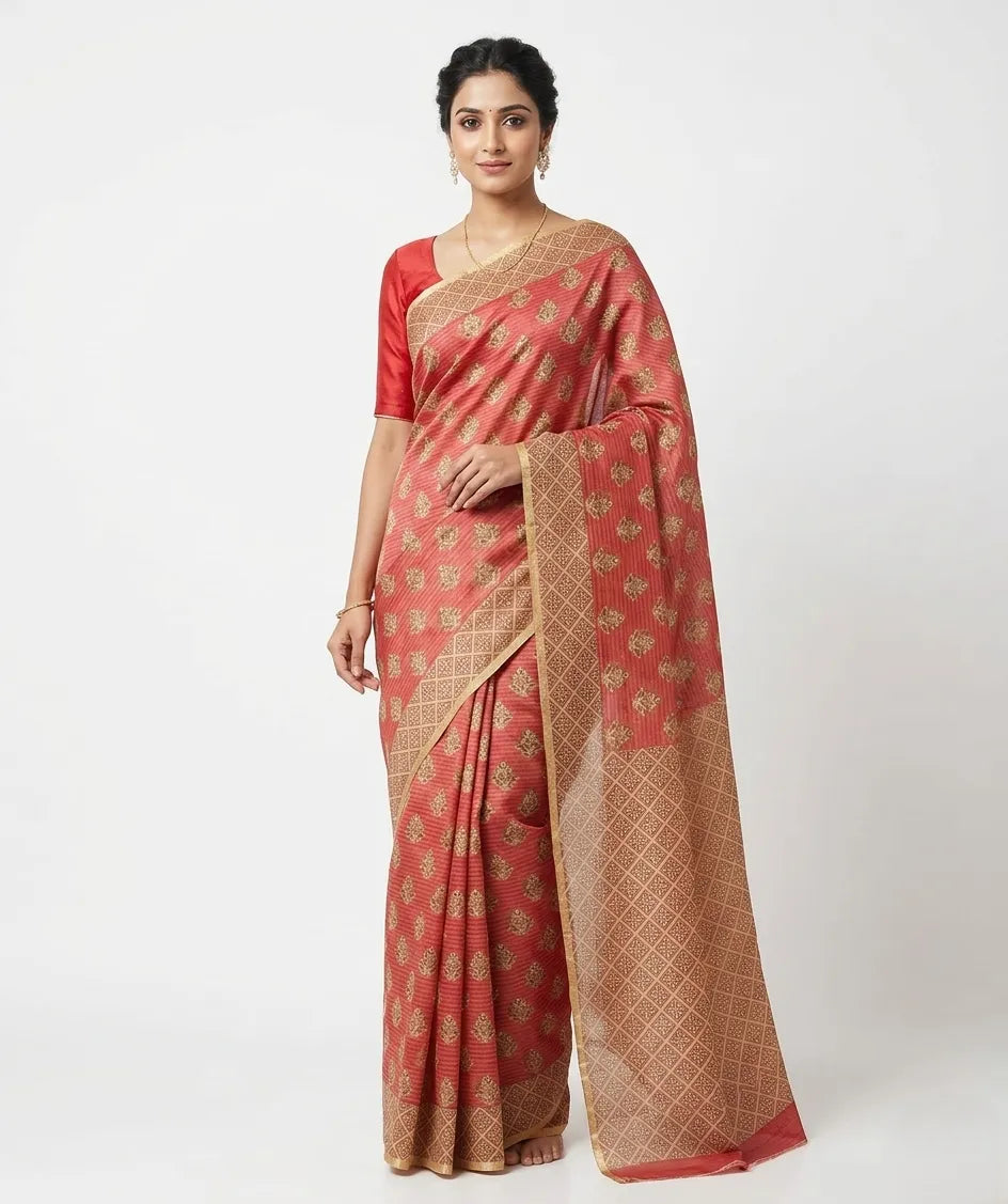 Woman in a red and gold woven design art silk saree with unstitched blouse piece.