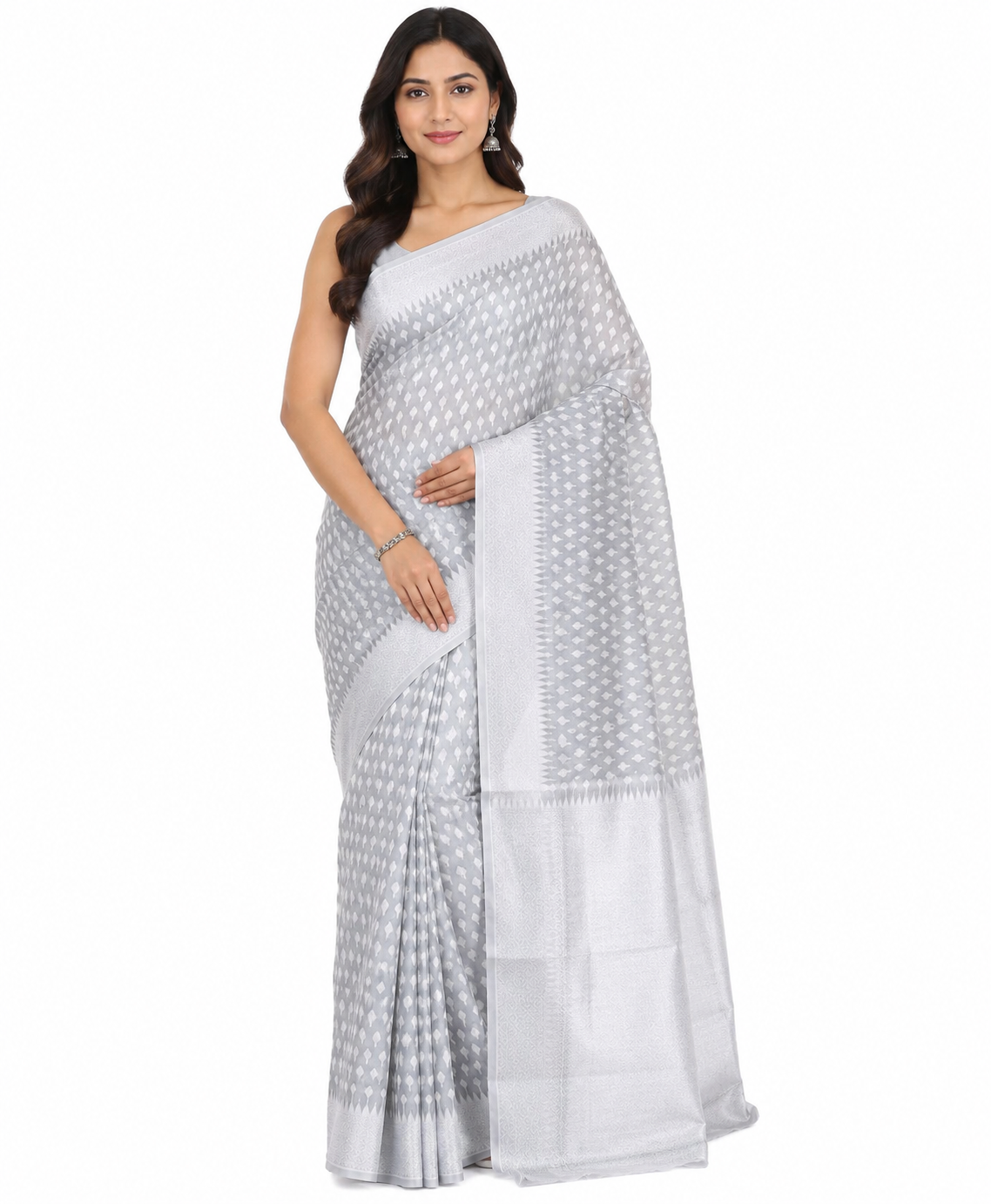 Woman in a silver Banarasi art silk saree with woven Zari details, posing against a white background.