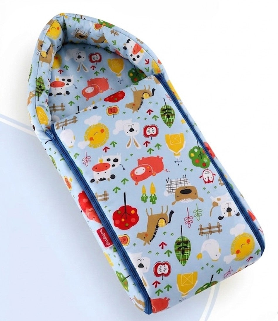 Light blue baby sleeping bag with colorful farm animal illustrations and blue side zippers.