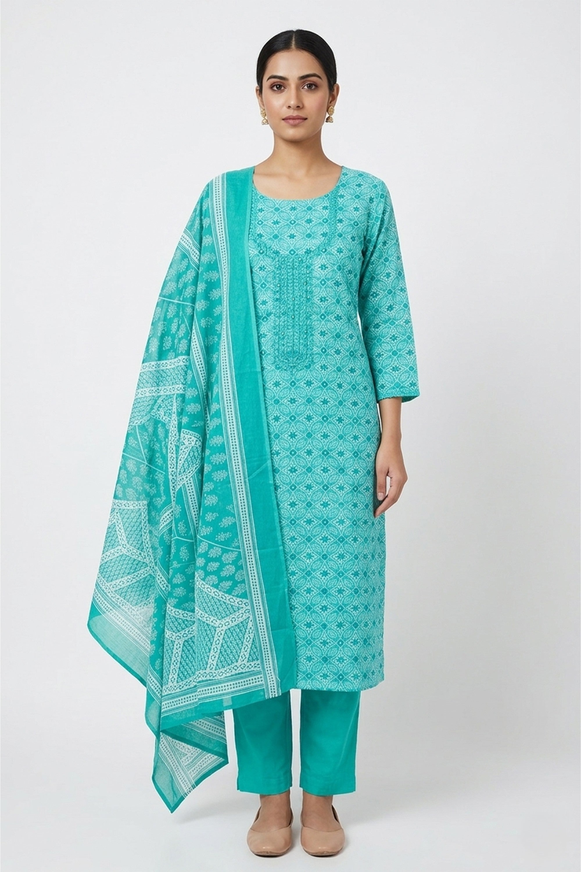 Sea green and white Bandhani printed cotton unstitched suit on a mannequin with tonal embroidery and matching dupatta.
