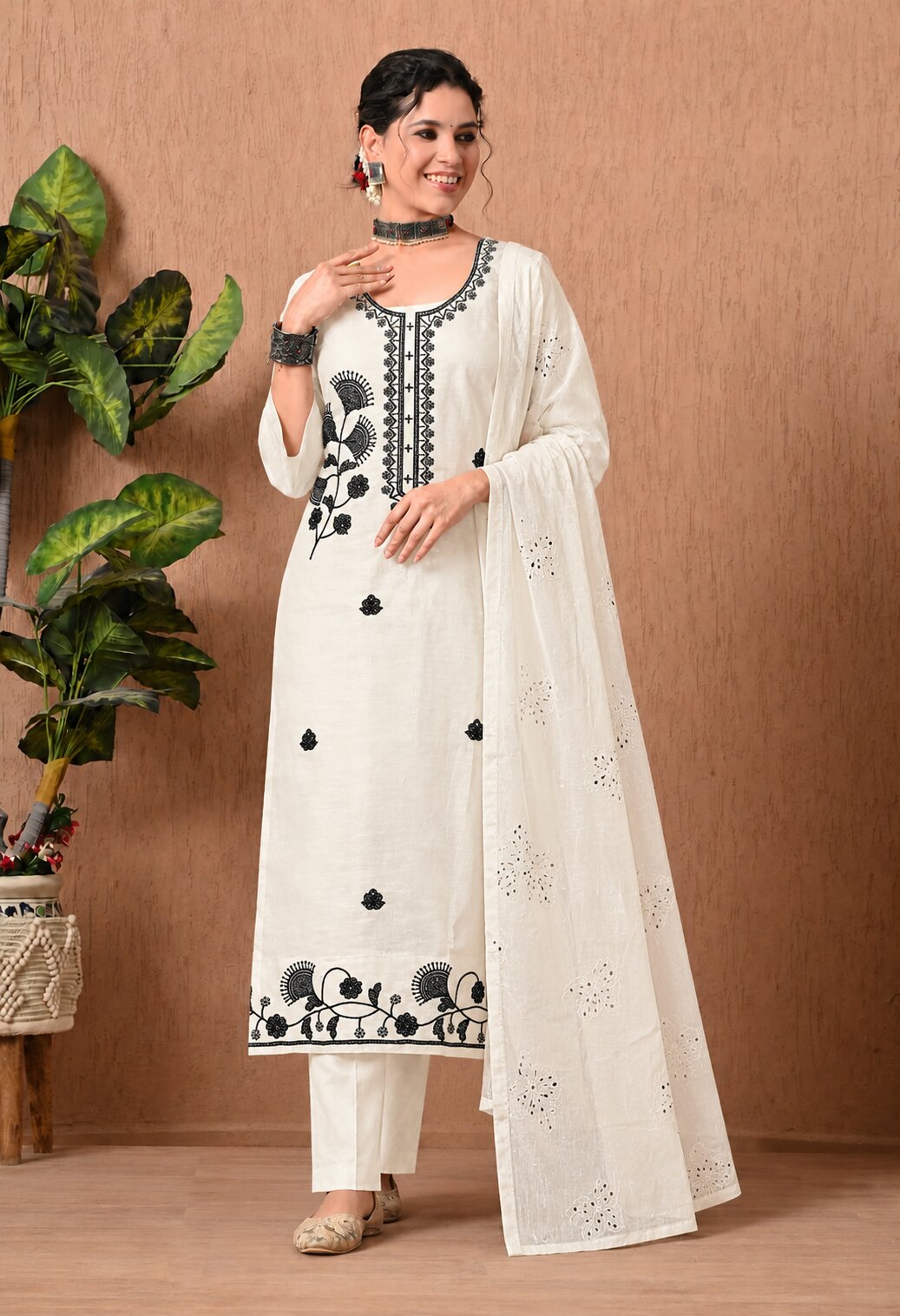 write alt text for this suit
Off-white straight-fit kurta suit set featuring black floral embroidery on the neckline, front, and hem, paired with matching straight pants and a coordinating off-white dupatta with delicate lace detailing and subtle embroidered motifs.