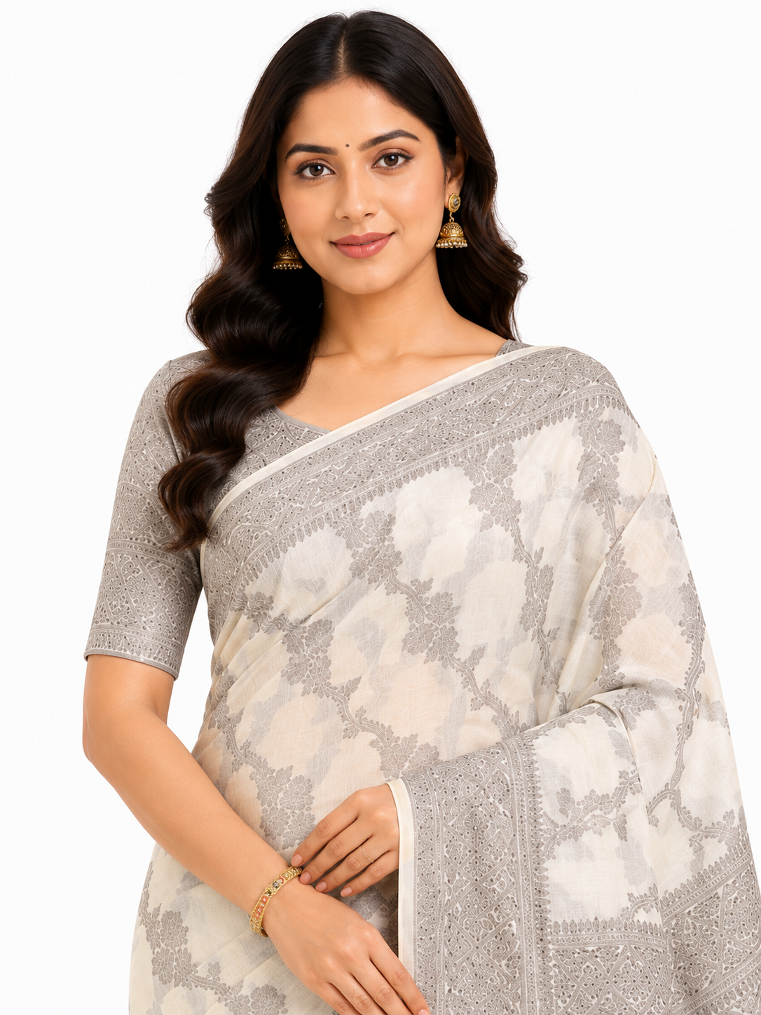 A woman posing in a luxurious Cream and Champagne-Gold Art Silk saree featuring intricate all-over ethnic woven motifs, a broad geometric zari border, and a rich metallic pallu.